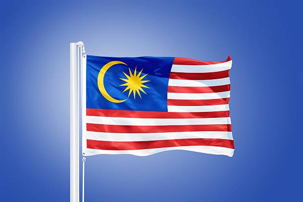 istock Flag of Malaysia flying against a blue sky 487689342