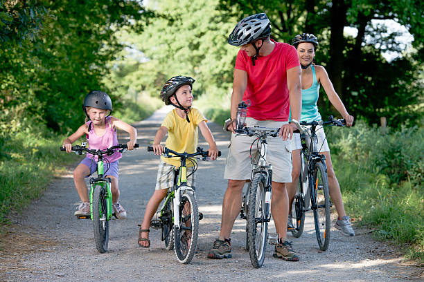 istock Family cycling in park 487690015