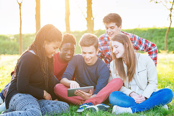 istock Teenage Friends using Digital Tablet at Park 487690487