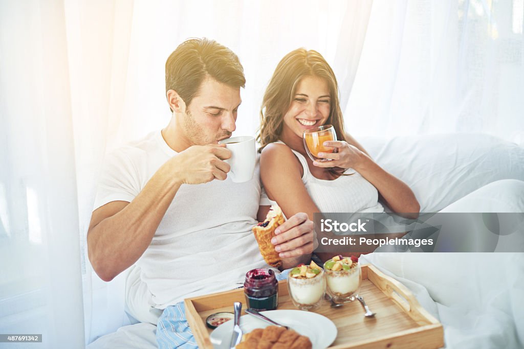 Breakfast is better when you share it in bed Shot of a loving young couple enjoying breakfast in bedhttp://195.154.178.81/DATA/i_collage/pi/shoots/783281.jpg Breakfast Stock Photo