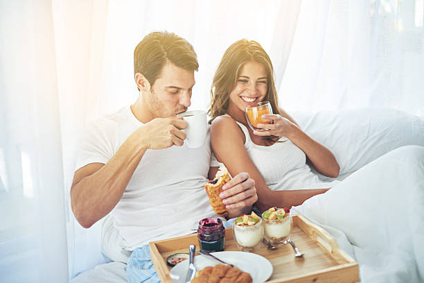 Breakfast is better when you share it in bed Shot of a loving young couple enjoying breakfast in bedhttp://195.154.178.81/DATA/i_collage/pi/shoots/783281.jpg bed breakfast pictures stock pictures, royalty-free photos & images