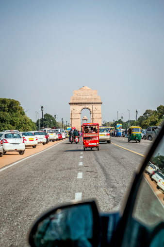 New Delhi, India - March 9, 2014: India Gate from Rajpath road. Image taken from the moving car.