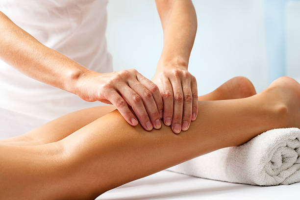 Detail of hands massaging human calf muscle. Detail of hands massaging human calf muscle.Therapist applying pressure on female leg. human leg stock pictures, royalty-free photos & images