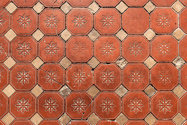 Hexagonal Floor Tiles Old Victorian hexagonal floral pattern floor tiles showing wear. terracotta stock pictures, royalty-free photos & images