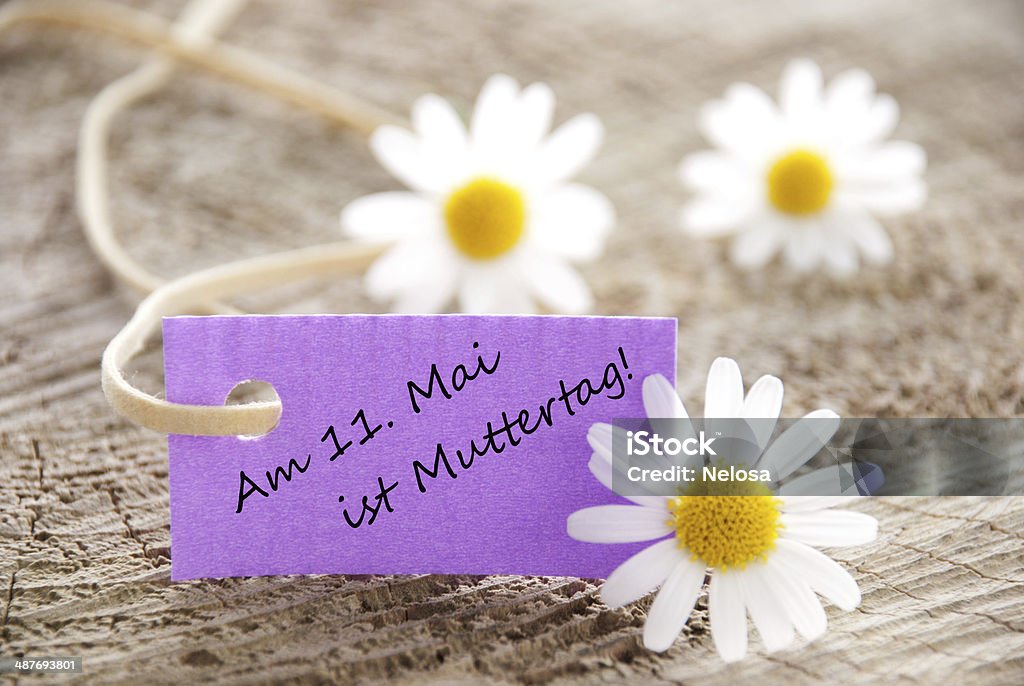 Purple Label with May 11 is Mother's Day A Purple Label with the German Words am 11. Mai ist Muttertag which means its Mothers Day on May 11th Anniversary Stock Photo