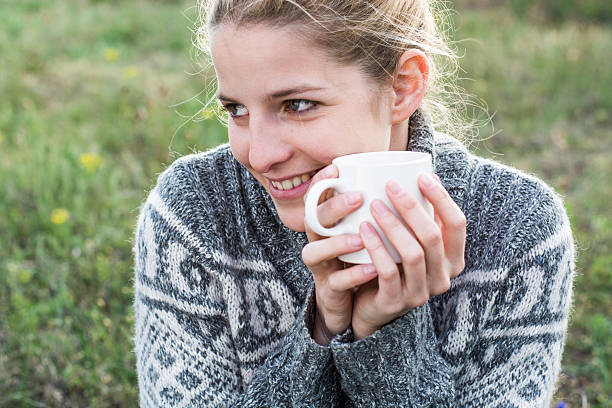 istock Woman holding cup outdoor 487694163