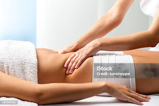 Therapist Doing Curative Belly Massage On Female Patient Stock Photo - Download Image Now