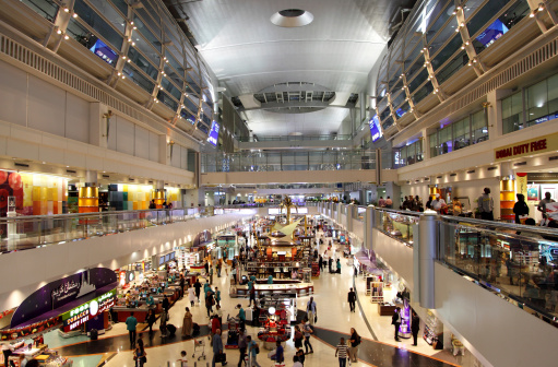 Dubai, United Arab Emirates - July 25, 2013:  Dubai International Airport with glorious duty free section on July 25, 2013. Dubai International is one of the fastest growing major hubs