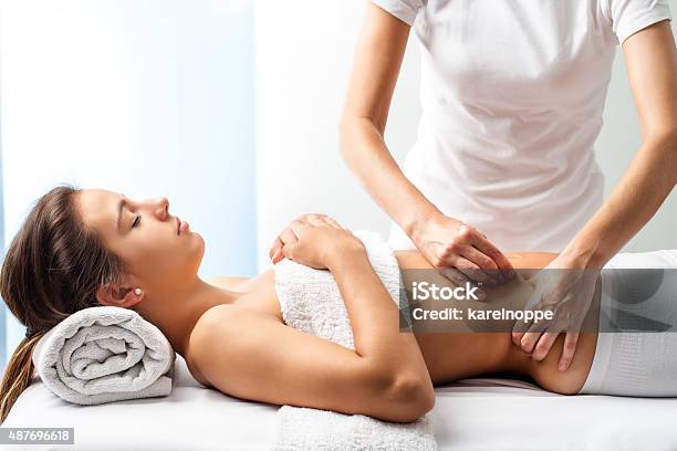 Therapist Doing Healing Massage On Female Abdomen Stock Photo - Download Image Now - Massaging, Massage Therapist, The Human Body