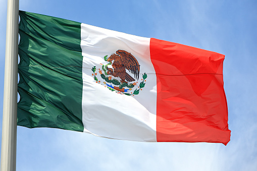 Mexico flag is flies with blue sky and clouds in Mexico City - Flag Waving