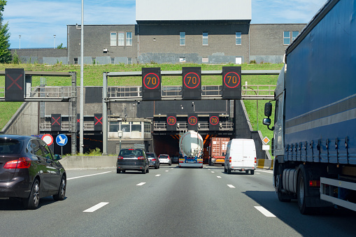 pov  driving on freeway in Belgium overtaking a blue truck  just before entering the Kennedy Tunnel in Antwerp Belgium