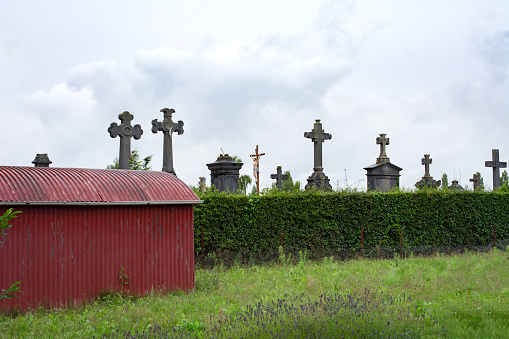 Crosses on old french graveyard in the rain