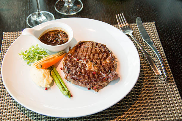 istock sirloin steak, served with asparagus, grilled carrot 487700448
