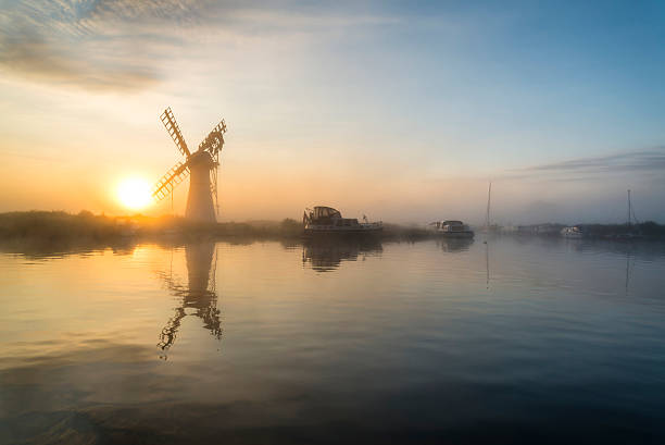 istock Stunnnig landscape of windmill and river at dawn 487701492