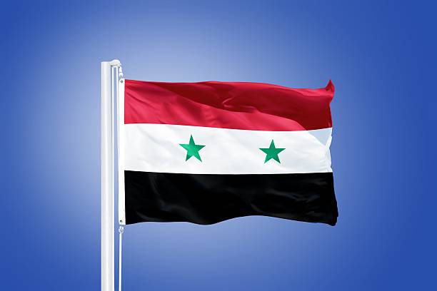 istock Flag of Syria flying against a blue sky 487701728
