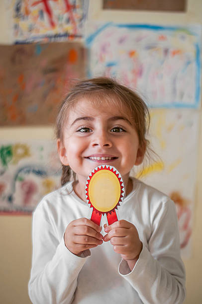 Little girl student with badge
