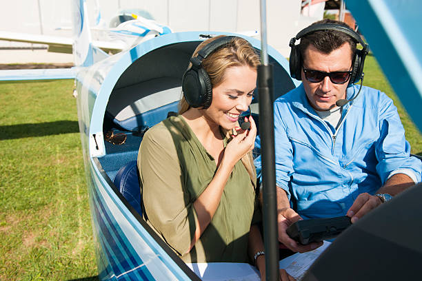istock Woman and man pilot looking at map, preparing for flying 487706634