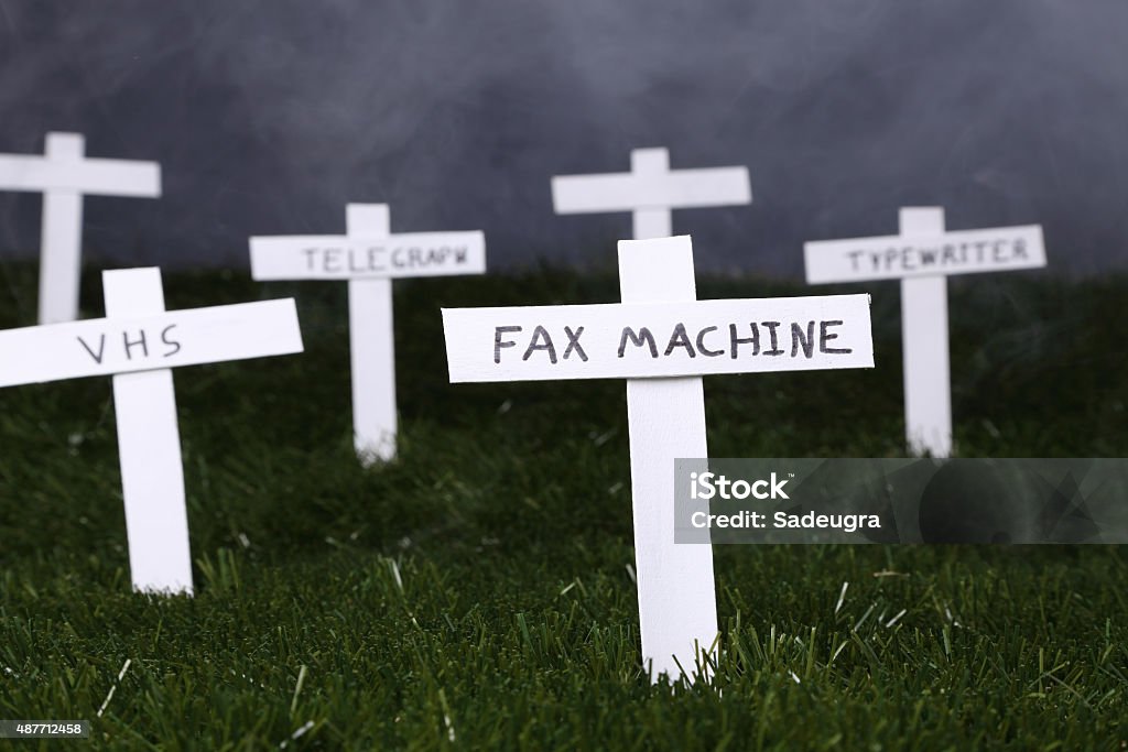 RIP Old Technology Graveyard for technology.  Concept for obsolete technology Fax Machine Stock Photo