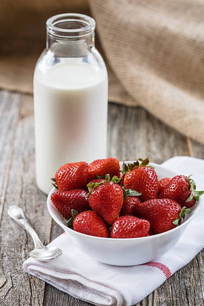 Fresh Strawberries with a Bottle of Milk stock photo