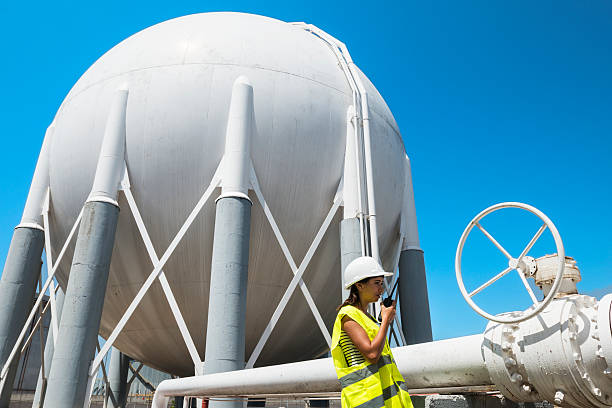istock Security personnel checking petrochemical tanks. 487718622