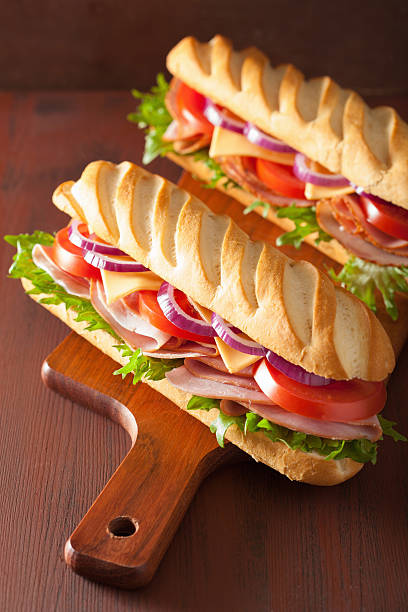 istock long baguette sandwich with ham cheese tomato lettuce 487718686