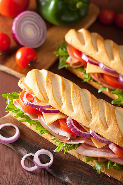 istock long baguette sandwich with ham cheese tomato lettuce 487718702