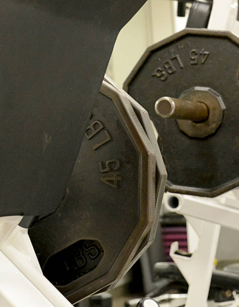 istock Iron weight plates and exercise equipment in gym 487720910