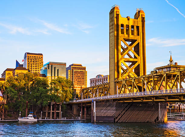 Golden Hour The buildings of downtown Sacramento California and the Tower Bridge illuminated by warm evening light.  sacramento photos stock pictures, royalty-free photos & images