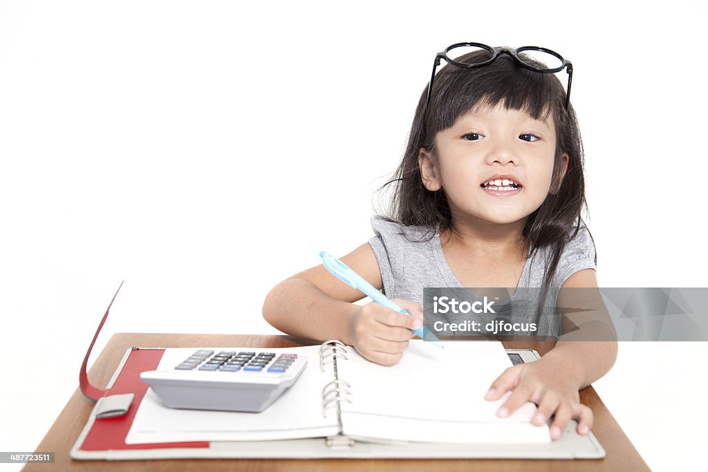 Little asian student girl with note book and calculator isolate Little asian student girl with note book and calculator isolate on white background Backgrounds Stock Photo