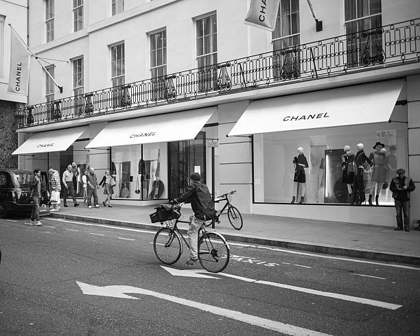 Woman cycling down New Bond Street, in Central London stock photo