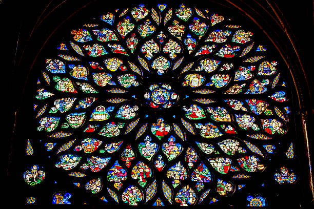 Jesus Sword Rose Window Stained Glass Sainte Chapelle Paris France Paris, France - June 1, 2015: Jesus Christ With Sword Biblical and Medieval Stories Rose Window Stained Glass Saint Chapelle Paris France.  Saint King Louis 9th created Sainte Chappel in 1248 to house Christian relics, including Christ's Crown of Thorns.  Stained Glass created in the 13th Century and shows various biblical stories along wtih stories from 1200s. sainte chapelle stock pictures, royalty-free photos & images