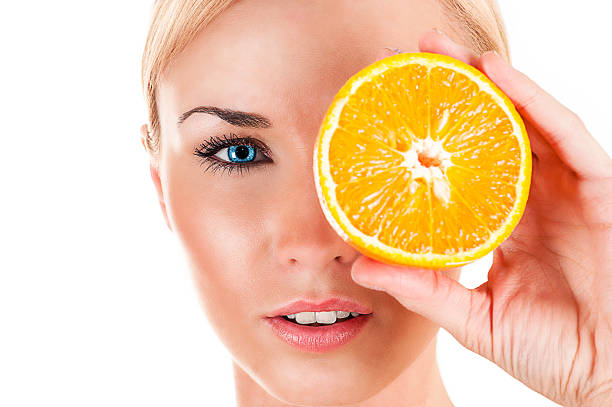 istock beautiful woman with orange 487724803
