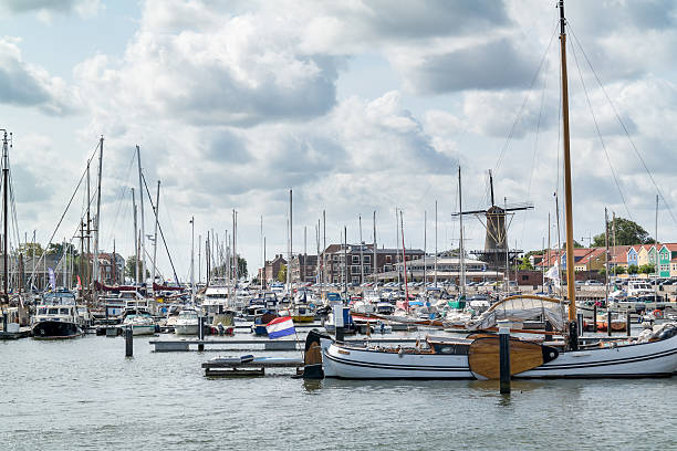 ветряная мельница и яхты в hellevoetsluis, нидерланды - hellevoetsluis стоковые фото и изображения