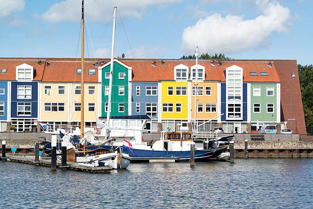 Hellevoetsluis, Netherlands - August 25, 2015: Colorful facades of wharf houses and boats in the city of Hellevoetsluis, Netherlands