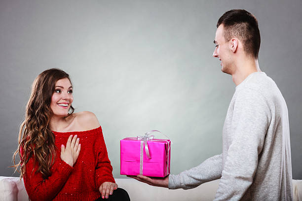 istock happy romantic couple with gift 487726156