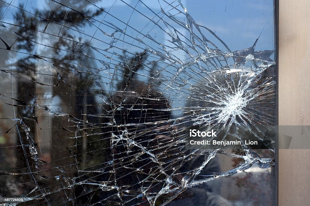 Broken Glass Broken Glass with outdoor street reflection. Closeup. Window Stock Photo