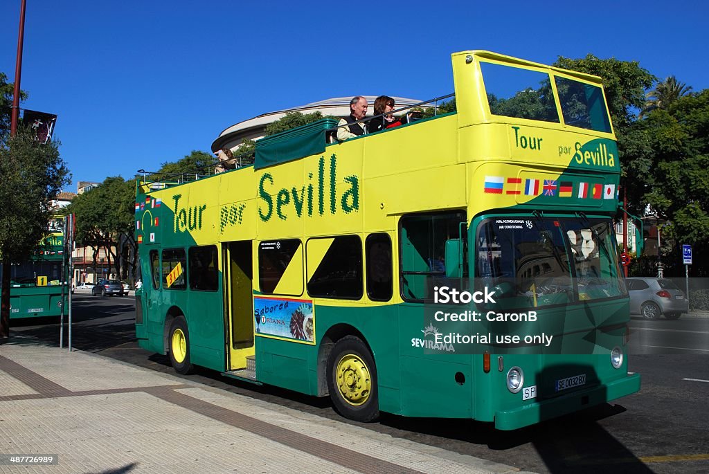 Tour bus, Seville, Spain. Seville, Spain - November 15, 2008:  Green and yellow City tour bus parked near the theartre, Seville, Spain, Western Europe. Andalusia Stock Photo