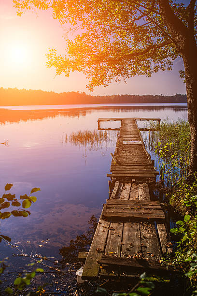 small wooden bridge on sunset stock photo