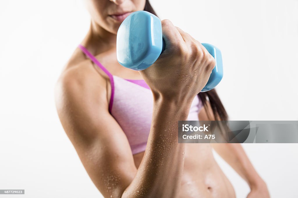 Female Fitness Closeup of a girl lifting weights Abdominal Muscle Stock Photo