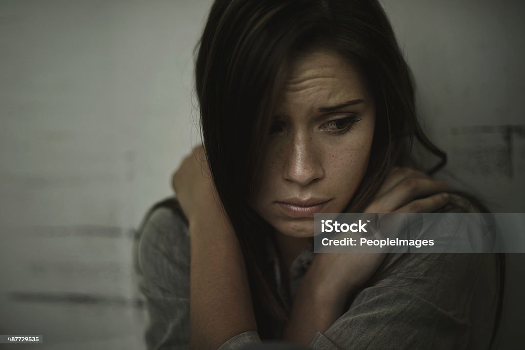 Lost and alone A young woman looking anxious and fearful Women Stock Photo