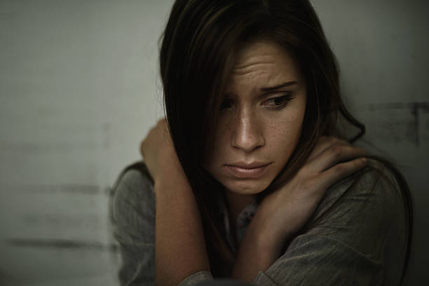 Lost and alone A young woman looking anxious and fearful schizophrenia photos stock pictures, royalty-free photos & images