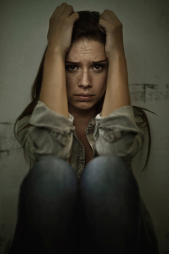 A young woman looking anxious and fearful