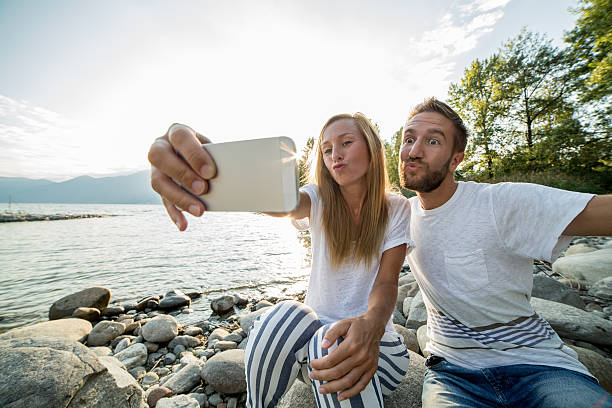 istock Beautiful young couple taking selfie by the lake 487736542