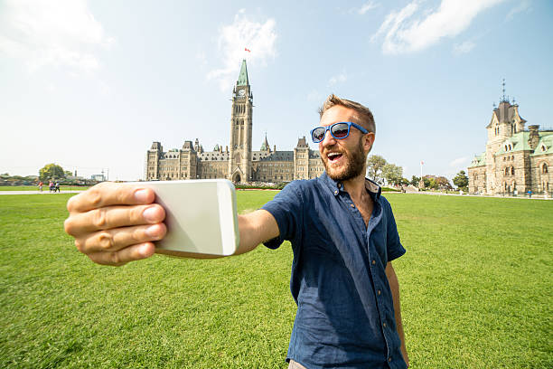 istock Young cheerful man in Ottawa-Canada taking a selfie portrait 487740854
