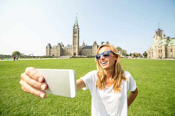 istock Young woman in Ottawa taking selfie in Summer 487740892
