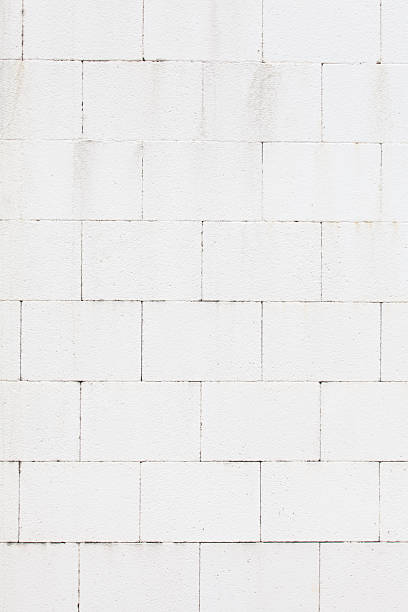 istock Texture and seamless background of white granite stone wall 487741066