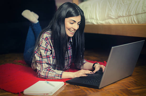istock Young Attractive Girl Using a Laptop 487744326