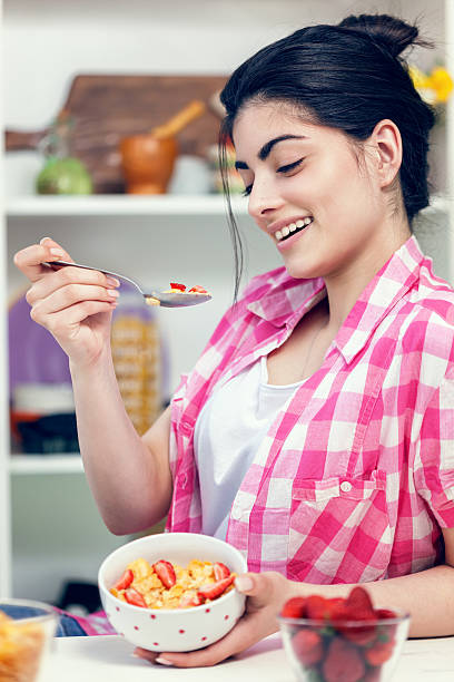 istock Young Beautiful Girl Having Breakfast 487744344