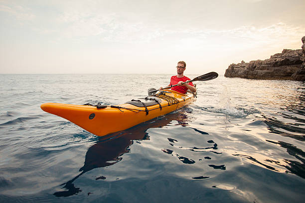 istock Young man in a kayak at sea 487744414