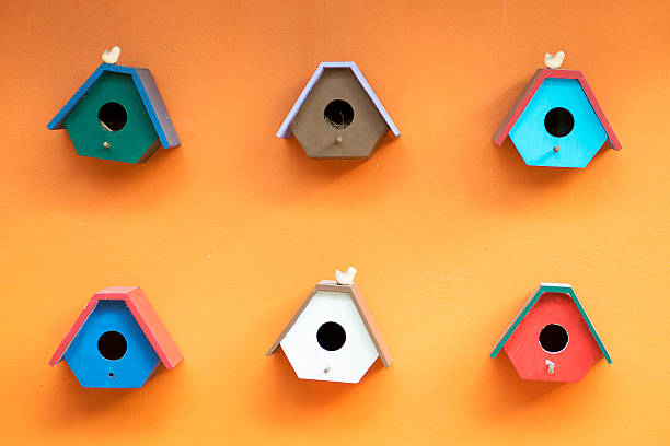 bird Houses on orange wall.